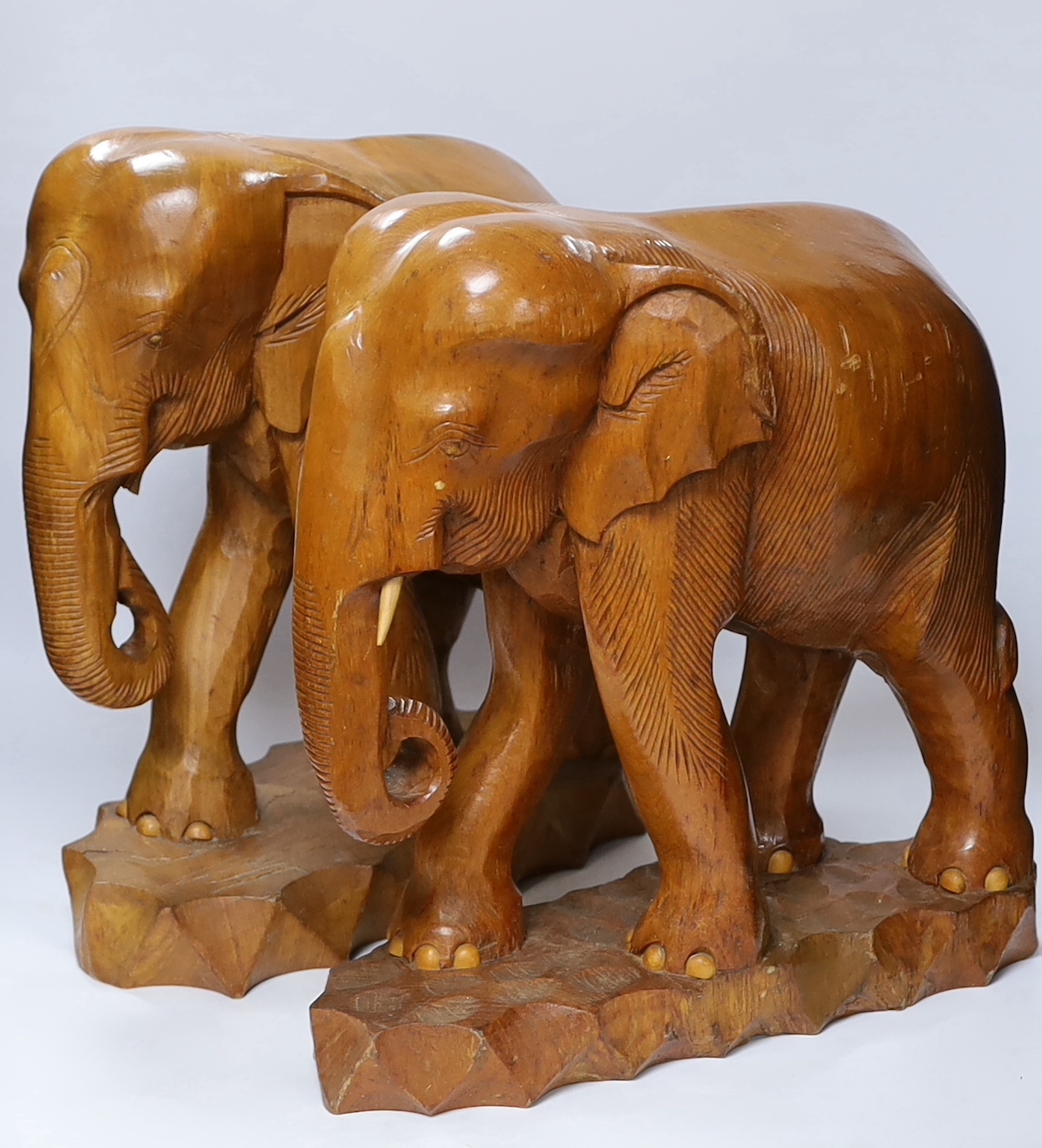 A pair of carved teak elephants, 42cm high